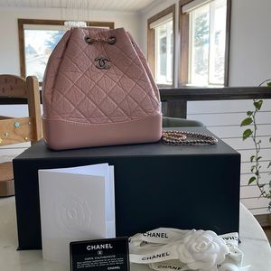 Used. Chanel back pack with silver and gold chain.